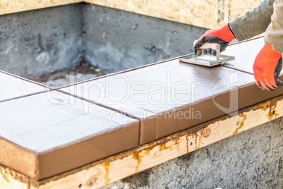 Construction Worker Using Hand Groover On Wet Cement Form
