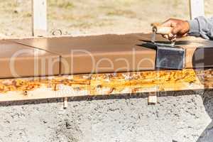 Construction Worker Using Stainless Steel Edger On Wet Cement Fo