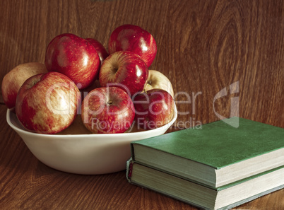 Vase with apples and books