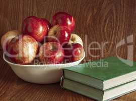 Vase with apples and books