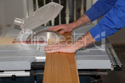 Worker laying parquet flooring. Worker installing wooden laminate flooring.