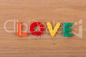 The word LOVE is laid out from colored plastic letters