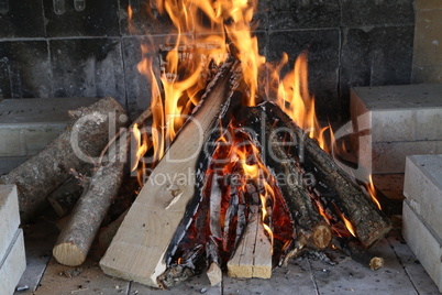 Fire, flame and hot firewood for grilling