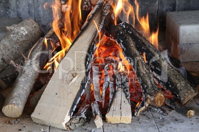 Fire, flame and hot firewood for grilling