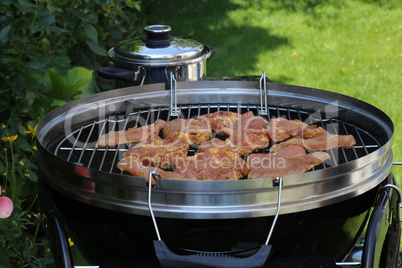 Meat and sausages are fried on the grill