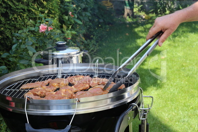 Meat and sausages are fried on the grill