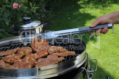 Meat and sausages are fried on the grill