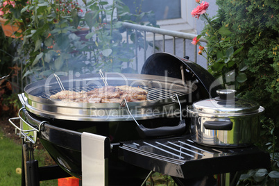 Meat and sausages are fried on the grill