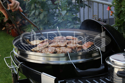 Meat and sausages are fried on the grill