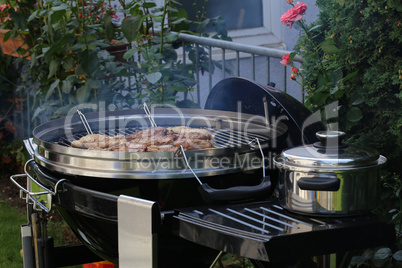 Meat and sausages are fried on the grill