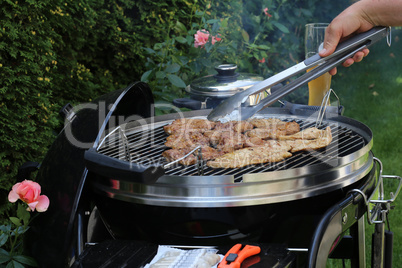 Meat and sausages are fried on the grill