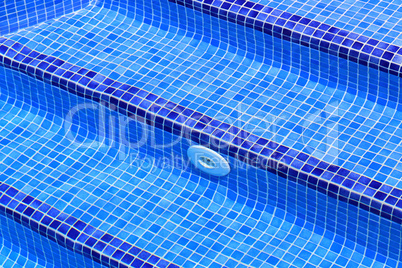 Steps in the pool lined with their blue tiles