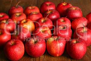 Beautiful red apples are on the table
