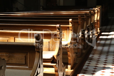 Empty church bench also called wooden pew without people