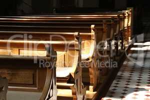 Empty church bench also called wooden pew without people