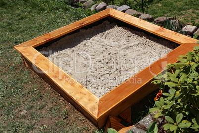 Newly built sandbox for small children in the garden