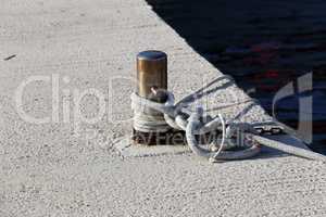 Bollard with a mooring line wrapped around it