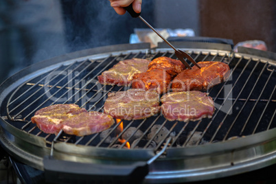 Meat and sausages are fried on the grill