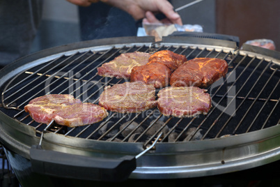 Meat and sausages are fried on the grill