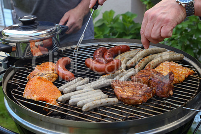 Meat and sausages are fried on the grill