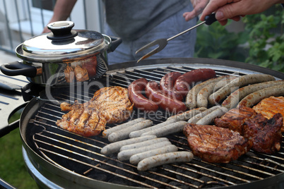 Meat and sausages are fried on the grill