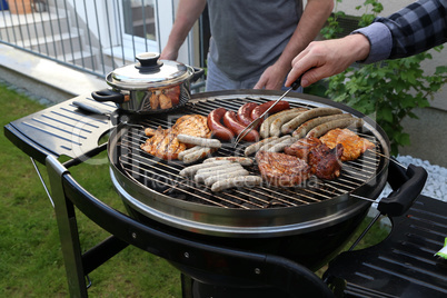 Meat and sausages are fried on the grill