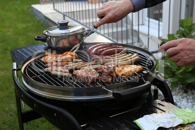 Meat and sausages are fried on the grill