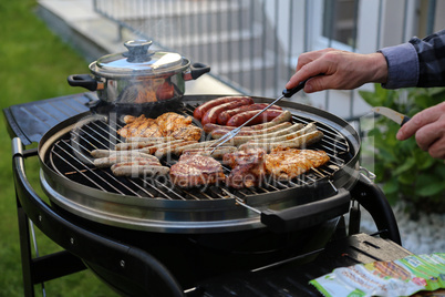 Meat and sausages are fried on the grill