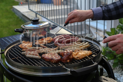 Meat and sausages are fried on the grill