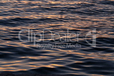 Sea waves in the rays of a sunset