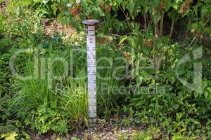 Large street thermometer stands in the garden