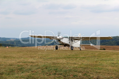 A small plane lands on the airfield