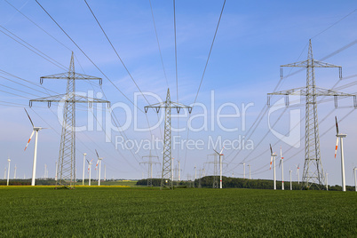 Landscape with high-voltage masts against the blue sky