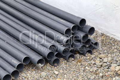 Plastic pipes lie on the construction site