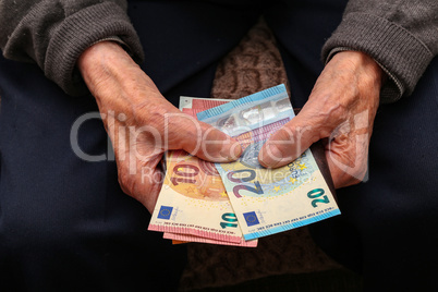 Pension / Money in the hands of an old man