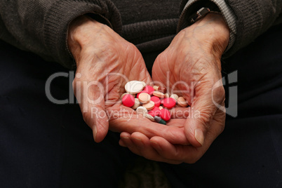Medication in the hands of an old man