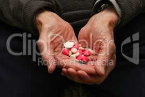 Medication in the hands of an old man