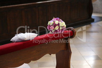 The brides wreath in the church lies on the edge of the pew