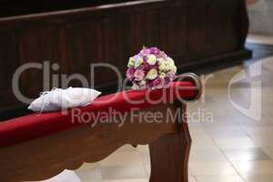 The brides wreath in the church lies on the edge of the pew