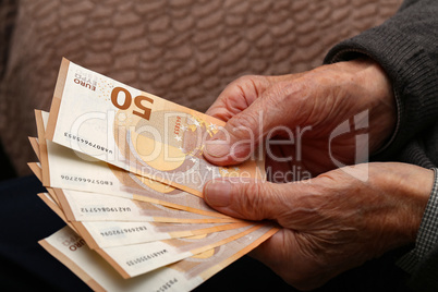 Pension / Money in the hands of an old man