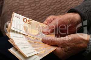 Pension / Money in the hands of an old man