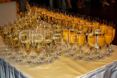 Glasses with champagne and juice are on the table