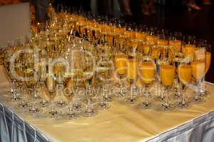 Glasses with champagne and juice are on the table