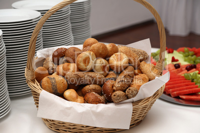 A basket with fresh buns is on the table