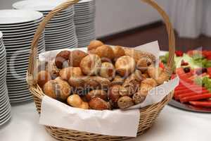 A basket with fresh buns is on the table