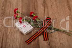 Red carnation with St. Georges ribbon is the symbol of Victory Day