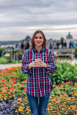 Beautiful young woman holding coffee cup