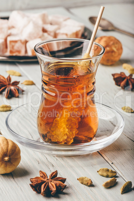 Tea in glass with turkish delight, different spices and navat sugar