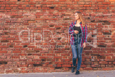 Portrait of young woman in shirt and jeans