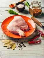 chicken leg quarter on plate with different spices